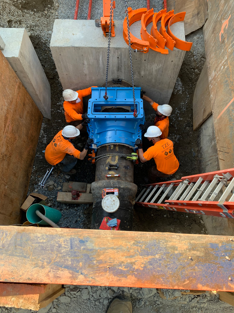 Close-up of a water main tapping connection